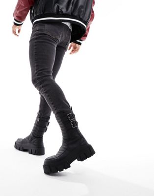 chunky boots in black faux leather with padding and buckle details