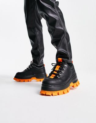 chunky lace up shoe in black faux leather with contrast orange sole