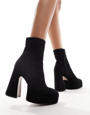 Enchant heeled platform boots in black micro