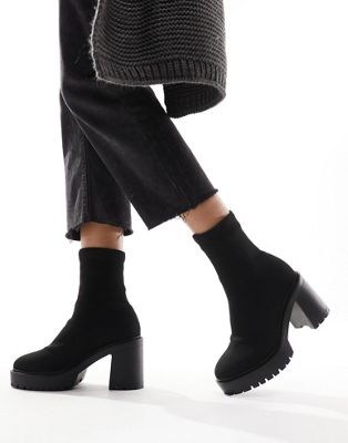 Explore chunky heeled sock boots in black
