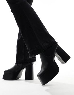 knee high platform heeled boots in black faux leather