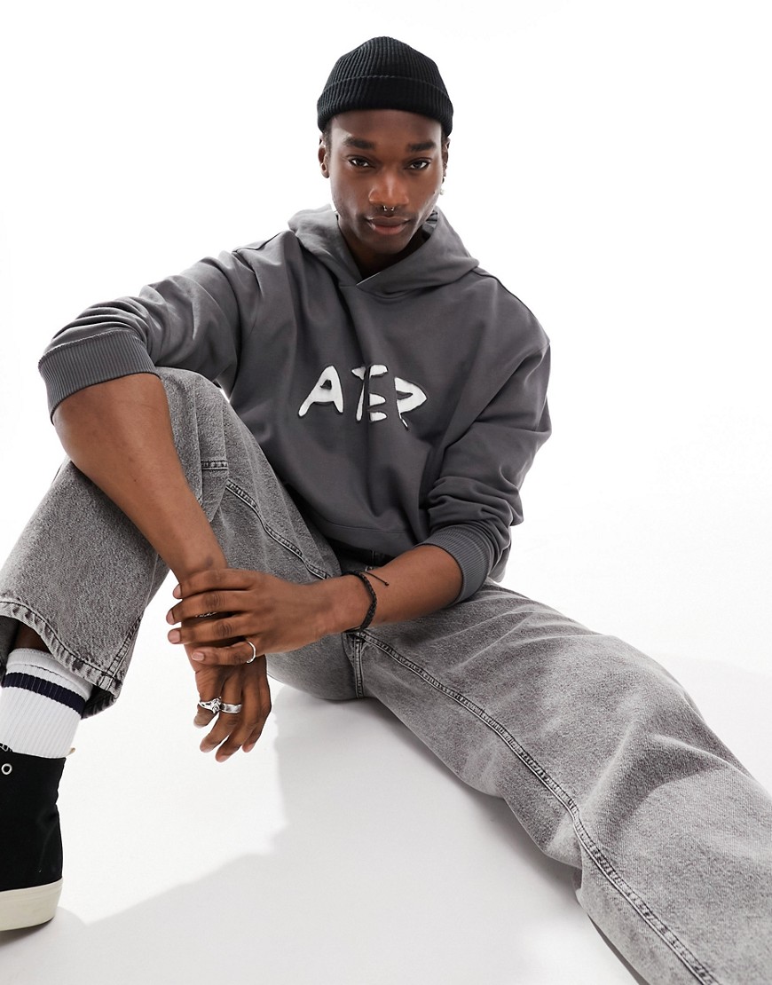 ASOS DESIGN oversized hoodie with cut out text print in charcoal grey