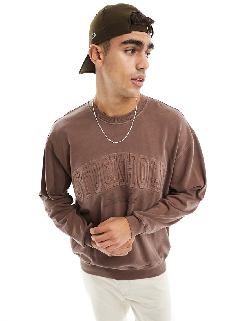 ASOS DESIGN oversized sweatshirt in brown with Stockholm embossed city print