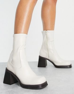 Reversed mid-heel sock boots in off white