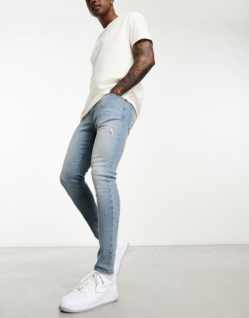 ASOS DESIGN spray on jeans with power stretch with rips in blue