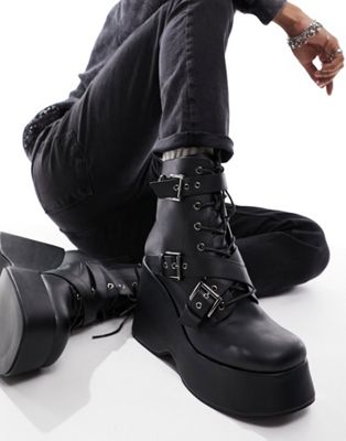 wedge heeled boots in black faux leather with buckle detail