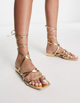 vinny strappy tie leg flat sandals in gold