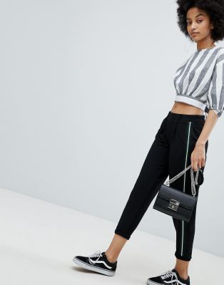 black pants with green side stripe