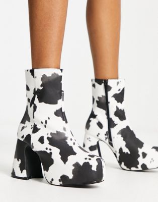 platform heeled ankle boots in cow print