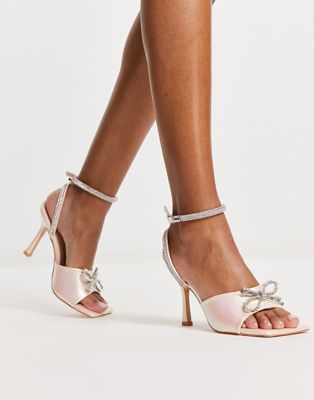 Exclusive Front Row bow sandals in pearlescent pink