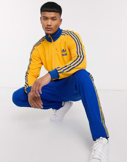 Migratie aftrekken werkplaats adidas Originals - Retro trainingspak in blauw en goud | ASOS