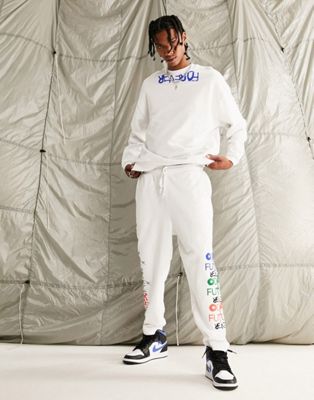 ASOS Dark Future co-ord relaxed joggers with graffiti logo graphic prints and fixed hem in white