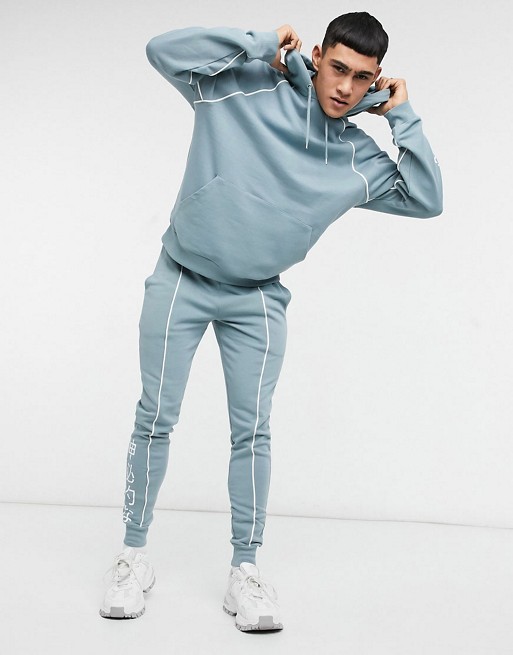 ASOS DESIGN co-ord skinny joggers in blue grey with piping & chinese text print