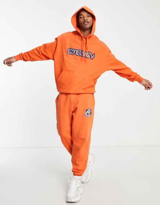 ASOS DESIGN oversized co-ord in orange with energy text print