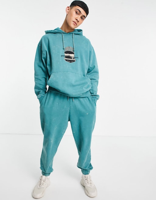 ASOS DESIGN set oversized tracksuit in acid wash with collegiate city print