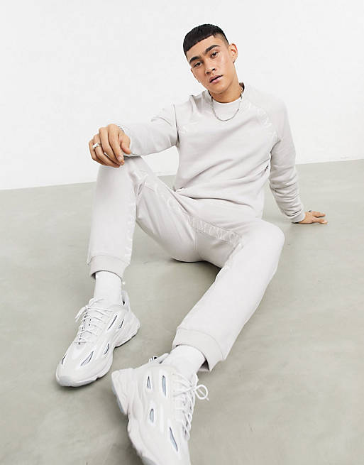 ASOS DESIGN tracksuit set with Roman numerals taping in dusty gray