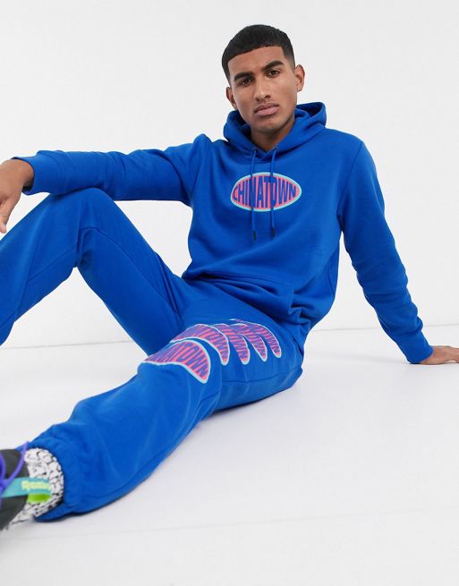 Chinatown Market Oval chest logo sweatsuit in blue | ASOS