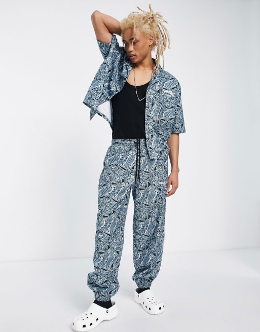COLLUSION woven short sleeve shirt and aughts fit sweatpants set with all-over print