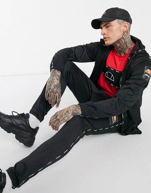 ellesse – Leichter Trainingsanzug mit Zierband in Schwarz