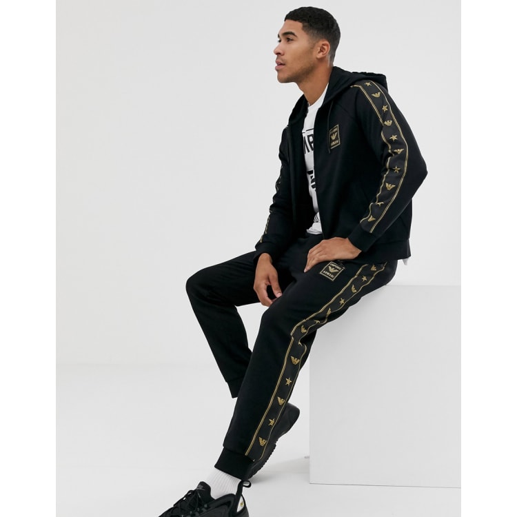 Ea7 black store and gold tracksuit