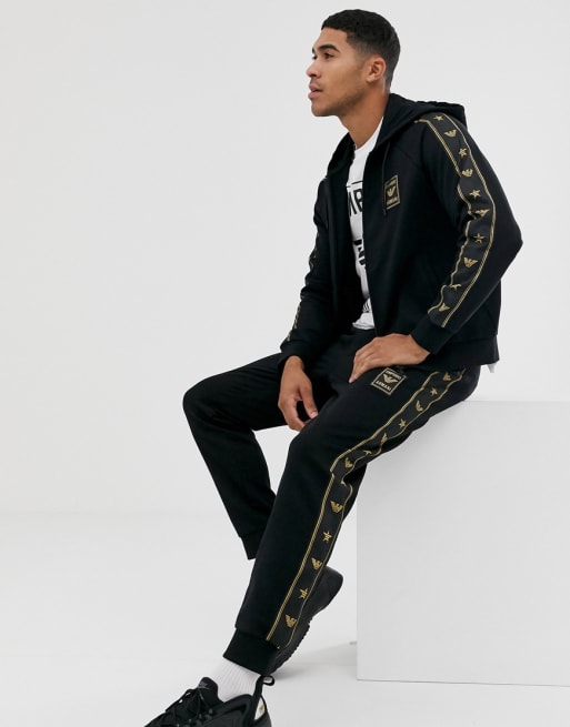 Emporio Armani gold logo taped tracksuit set in black ASOS