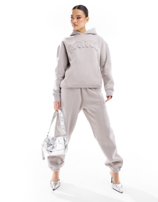 Murci - Coordinato con felpa oversize con cappuccio e joggers con fondo elasticizzato color pietra con scritta “Saint”