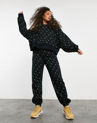 Nike all over logo print tracksuit in 