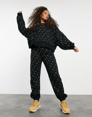 Nike all over logo print tracksuit in 