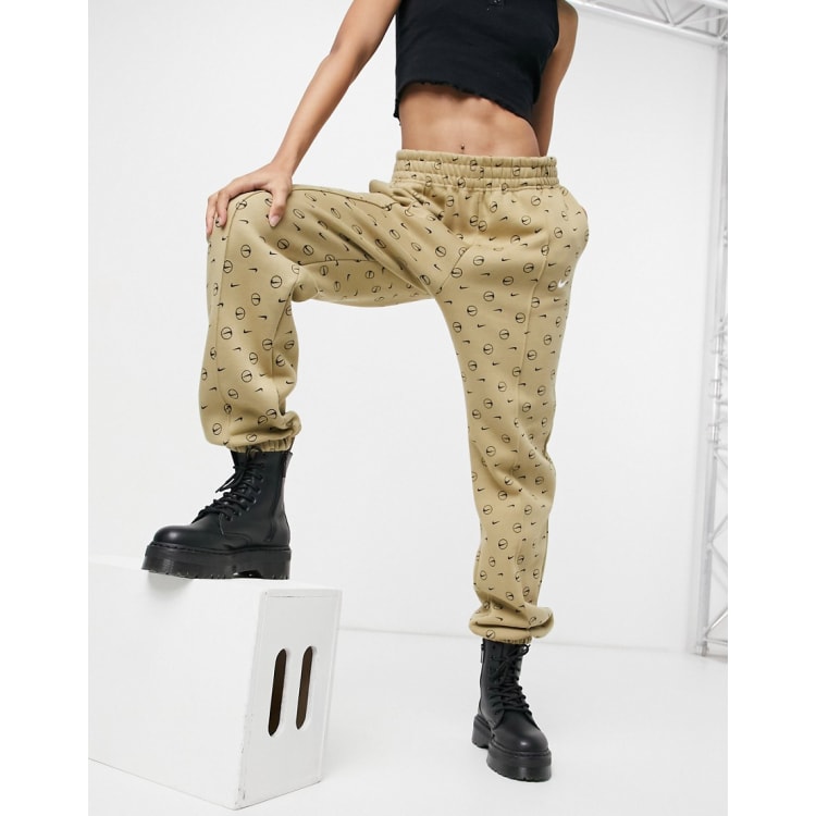 Nike all over logo print joggers in camel new arrivals