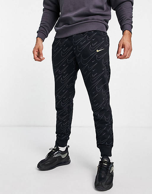 Nike all over swoosh print tracksuit in black | ASOS