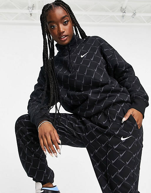 Nike oversized tracksuit in black with all over swoosh print