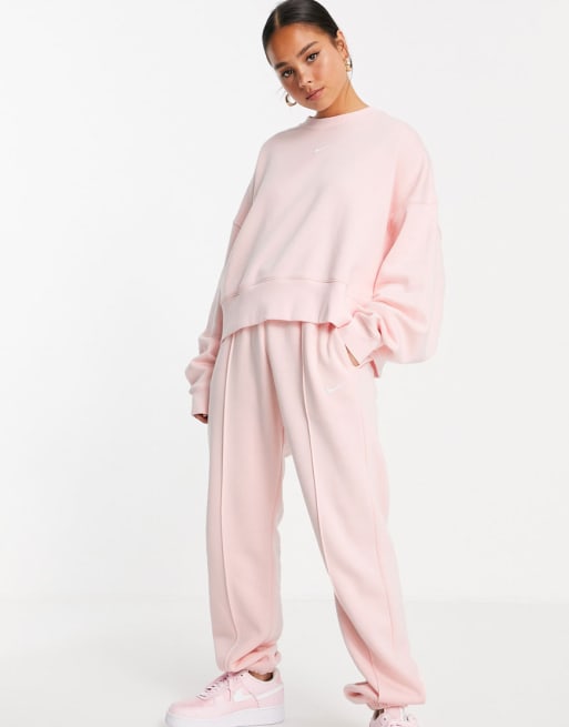 Nike – Polarowy dres z małym logo Swoosh w kolorze bladego koralu