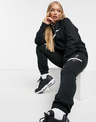 Nike swoosh crop and oversized jogger tracksuit in black | ASOS