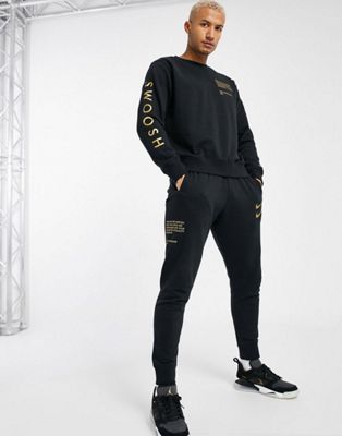 Nike Swoosh tracksuit set in black and 