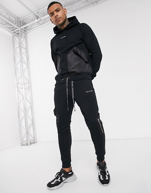 Religion tracksuit with utility contrast pockets in black