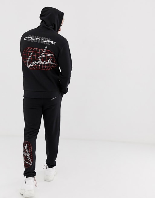 The Couture Club – Schwarzer Trainingsanzug mit Globus-Print am Rücken 