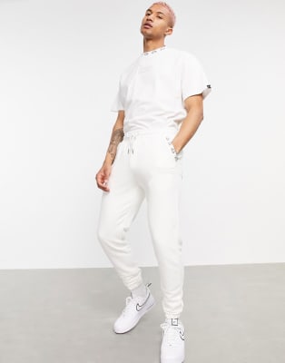 The Couture Club x Ellesse logo sweatsuit set in cream ASOS