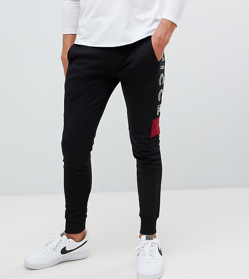Nicce skinny joggers in black with side logo exclusive to ASOS