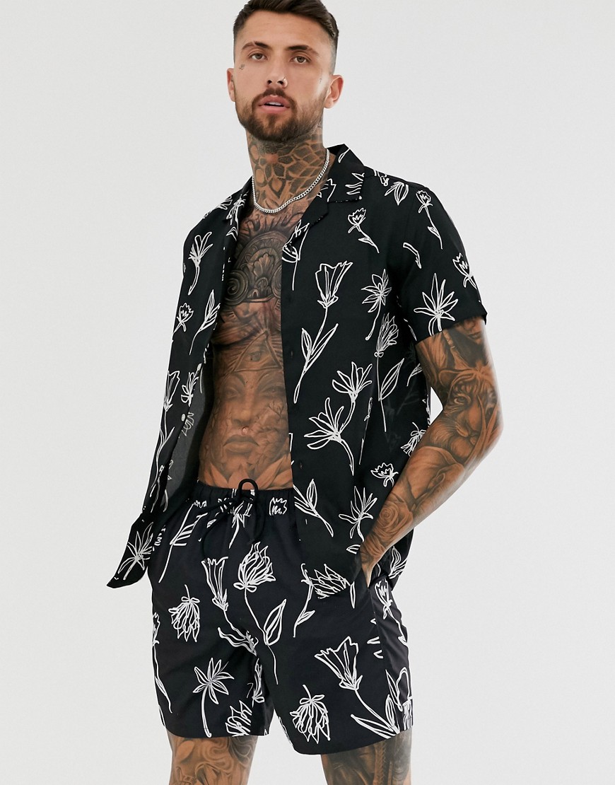 ASOS DESIGN co-ord swim shorts in black with hand drawn floral print in mid length