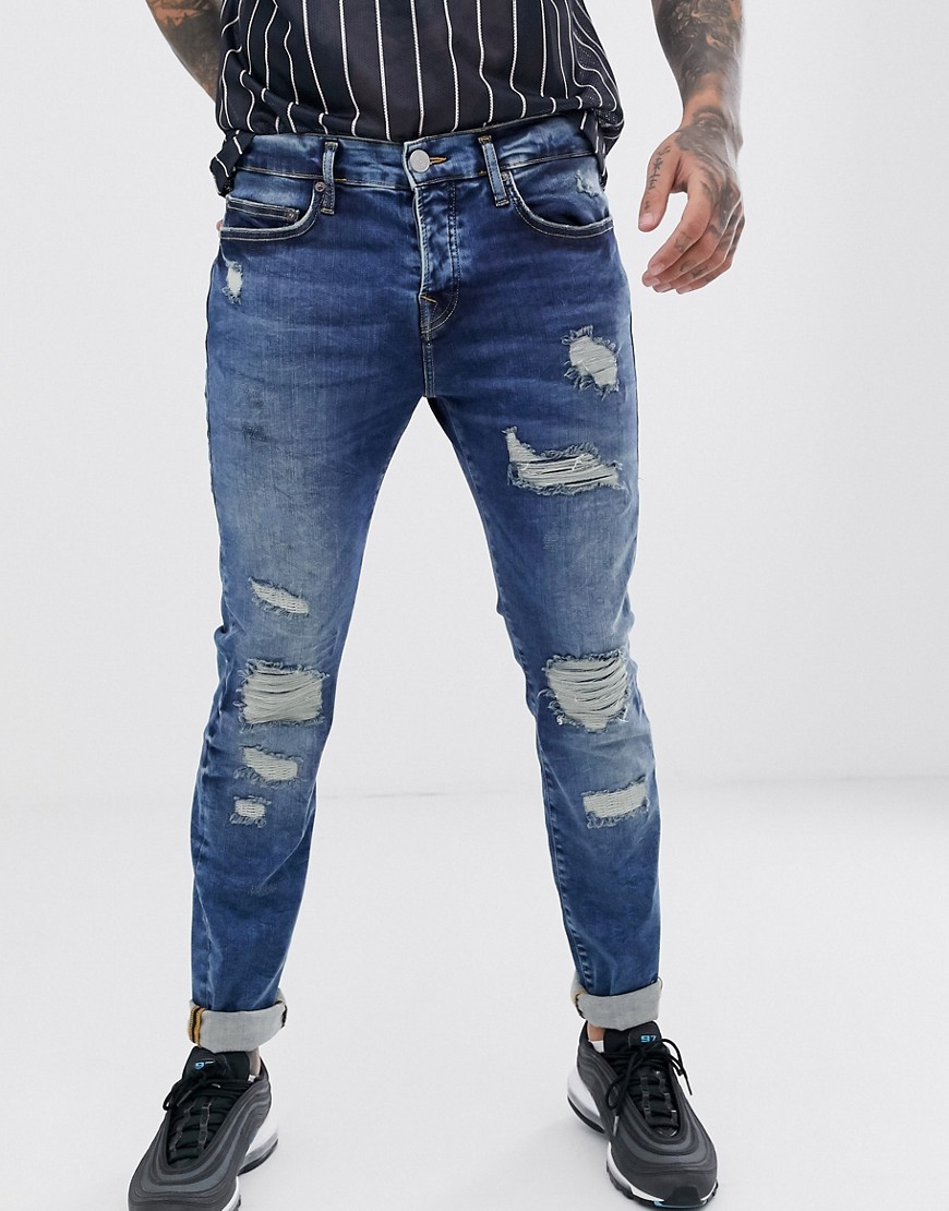 True Religion rocco slim jean with rip and repair biker detail in mid wash