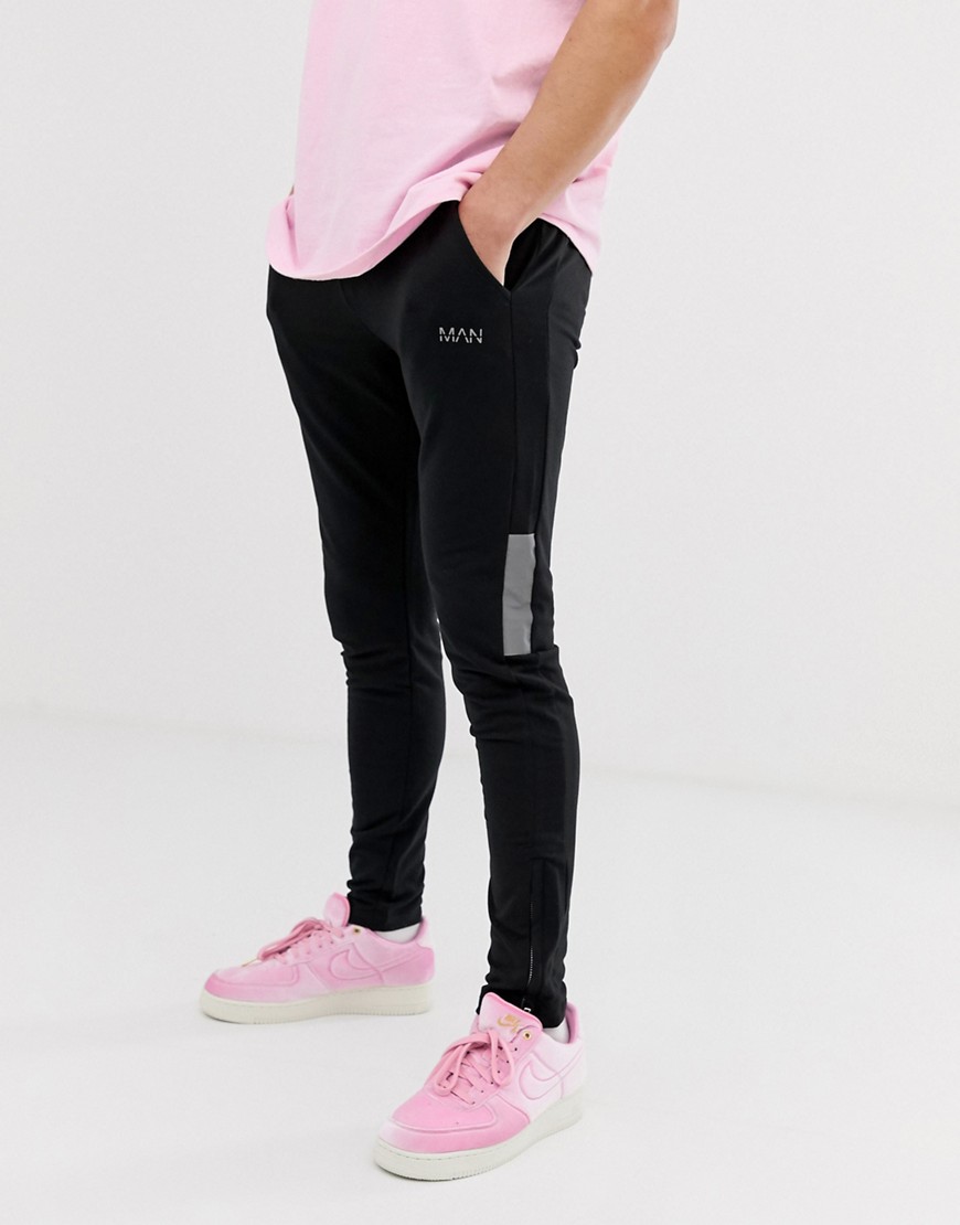 boohooMAN skinny joggers with reflective side panels in black