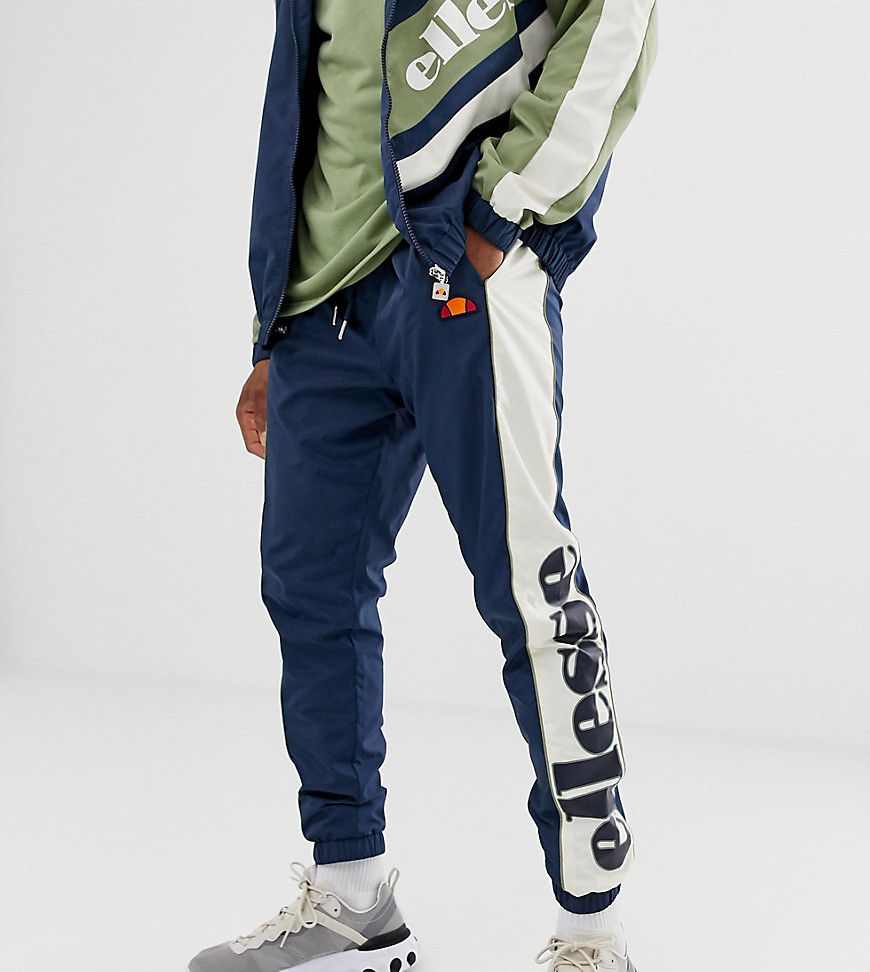 ellesse Gioele recycled woven track pants in navy/green exclusive at ASOS