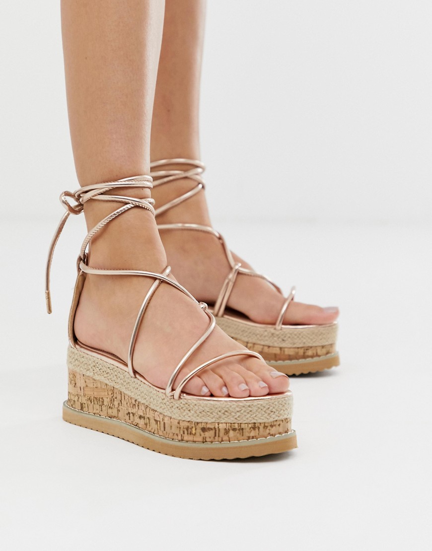 Truffle Collection tie leg flatform sandals in rose gold