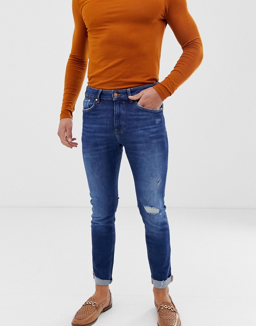 Bershka Join Life Organic Cotton skinny jeans in mid blue with knee rip and abrasions