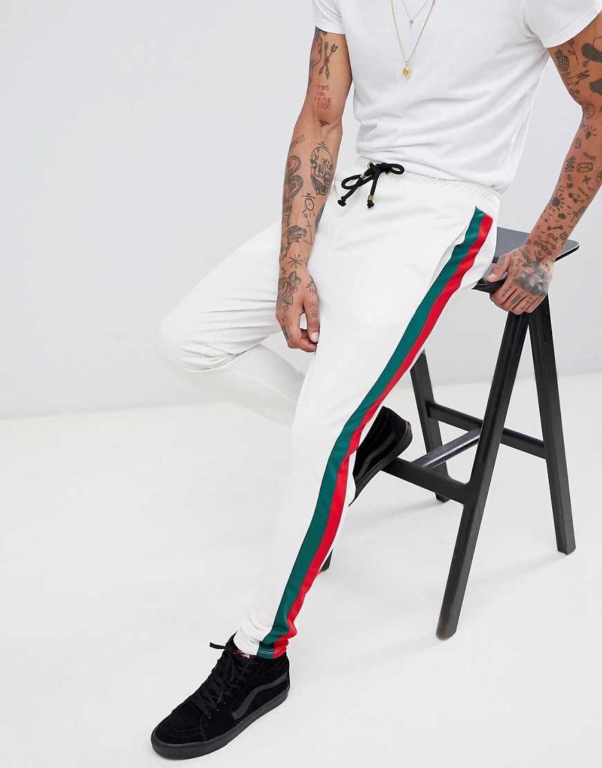 Criminal Damage skinny joggers in white with red side stripe
