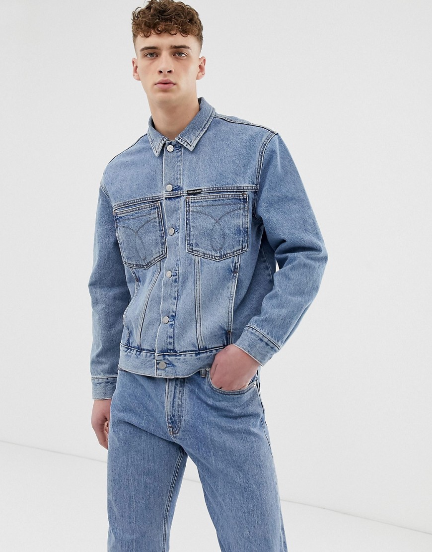 Calvin Klein Jeans iconic omega denim trucker jacket in mid stone wash