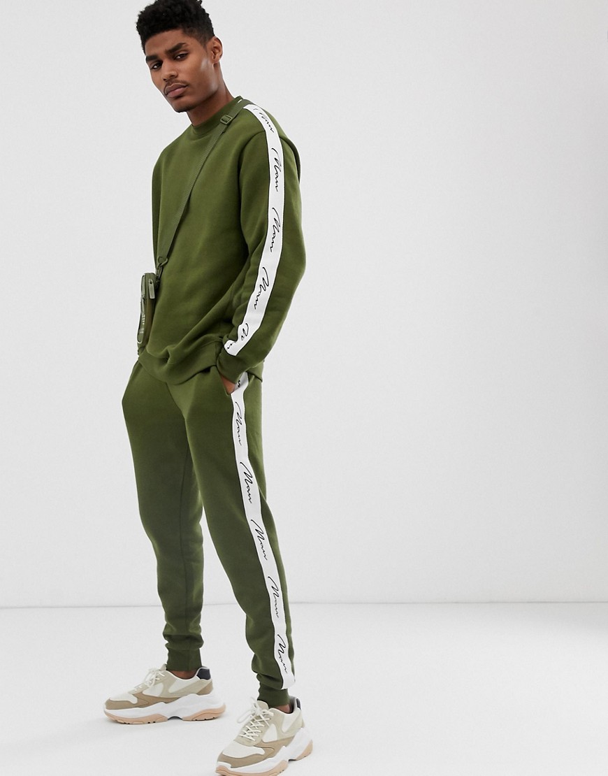 boohooMAN tracksuit with man taping in khaki