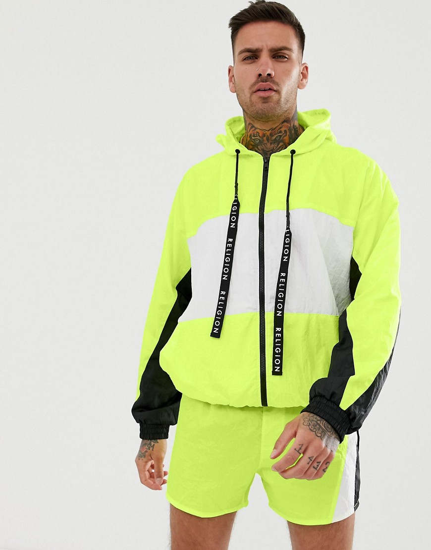 Religion track jacket with cut and sew panels in neon yellow