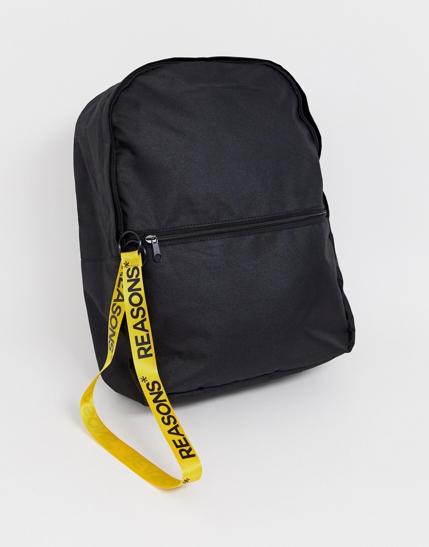 ASOS DESIGN backpack in black with yellow slogan zip pull