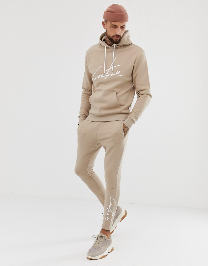 The Couture Club skinny joggers with signature logo in beige